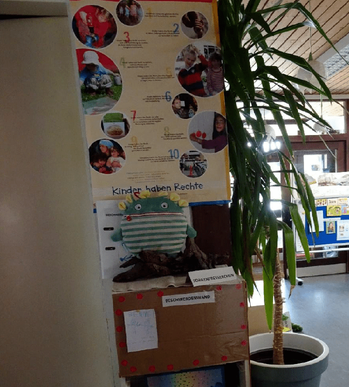 Selbstgestaltetes Plakat mit Kinderrechten im Eingang eines Kindergartens