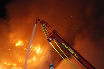 Der Wasserwerfer an der Gittermastspitze des Löschkranes der Ulmer Feuerwehr löscht aus ca. 30 Meter Höhe mit 4000 Liter Wasser pro Minute einen Großbrand in der Nacht.
