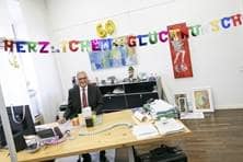 Luftschlangen und ein Band mit er Aufschrift "Happy Birthday" über dem Schreibtisch des Oberbürgermeisters